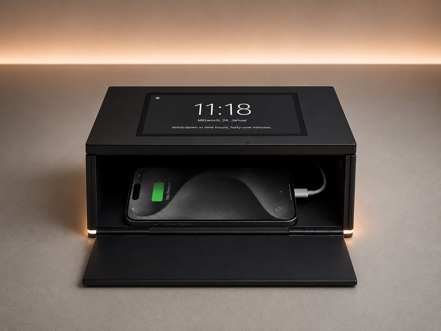 The Eudaimon bedside box: a calm clock on top showing 11:18 and a wind-down line, with a phone charging inside the closing drawer below.